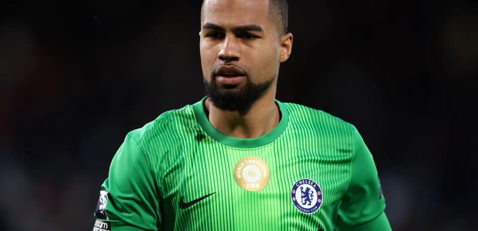 Goalkeeper wearing green kit with Chelsea badge