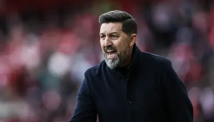 Manager gesturing during a match on the sideline