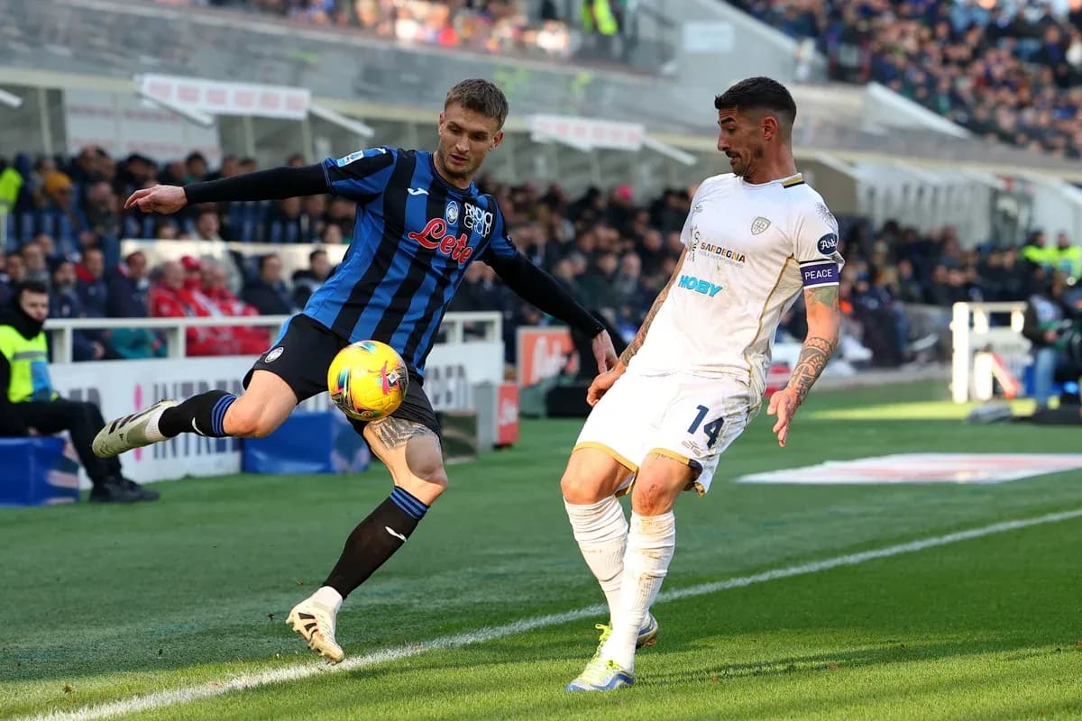 Cagliari player challenging Atalanta opponent for the ball