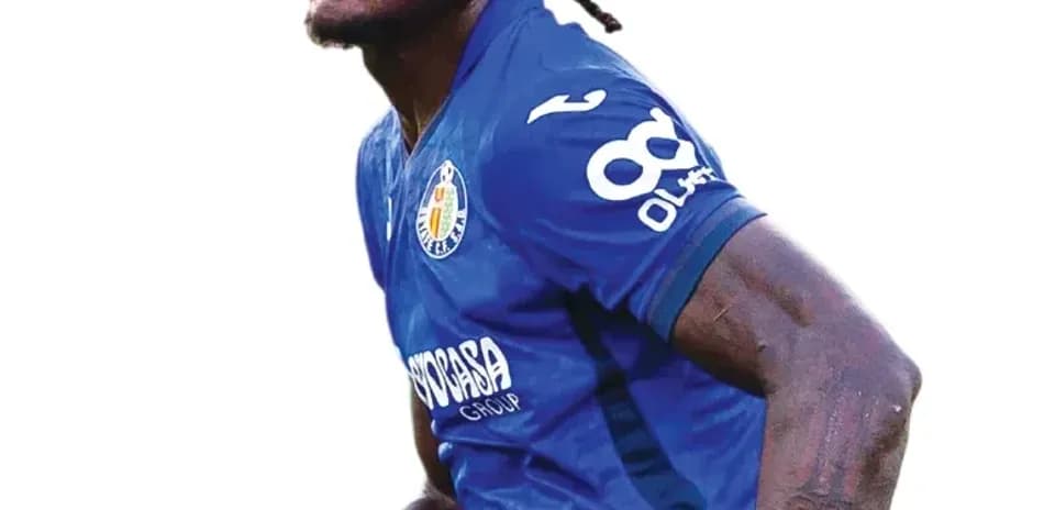Player celebrating in blue jersey during match