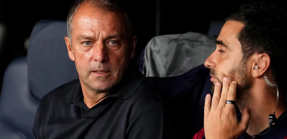 Two coaches discussing on the bench during match