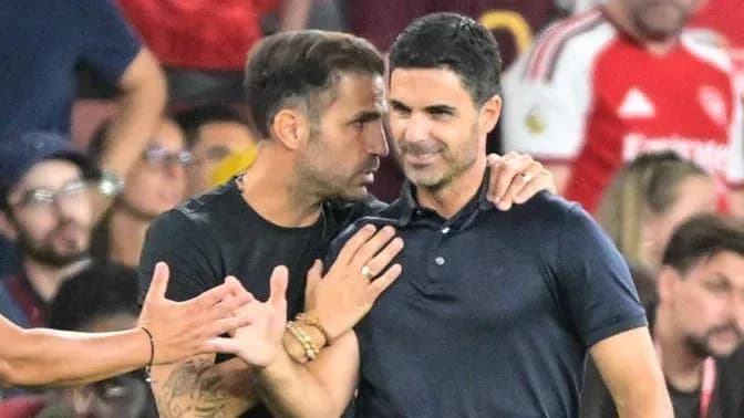 Two coaches discussing during a match on the sidelines