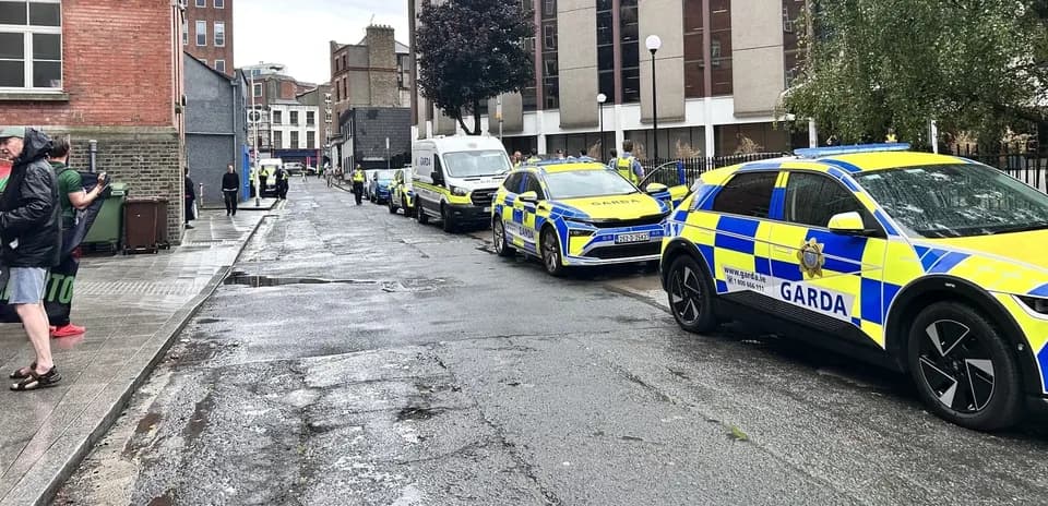 Police vehicles lined up on a city street
