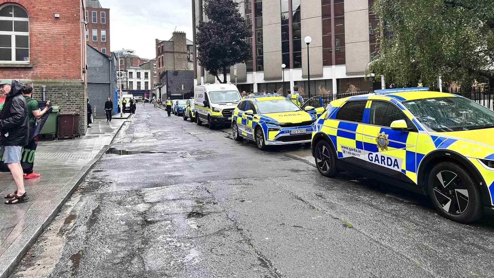 Police vehicles lined up on a city street