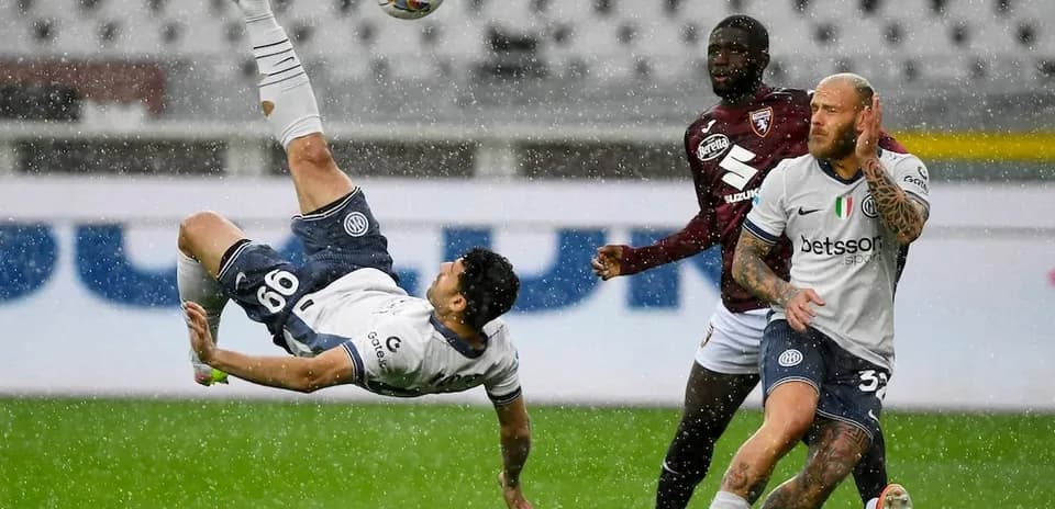 Player performing a bicycle kick in rain