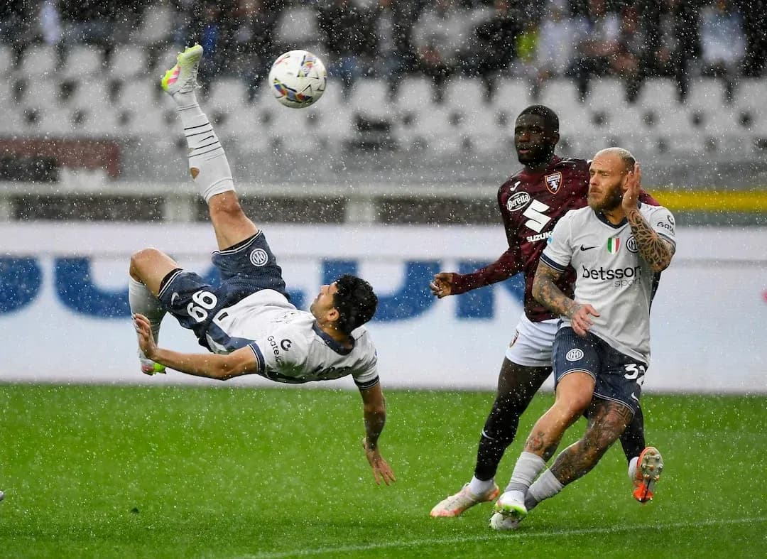 Player performing a bicycle kick in rain