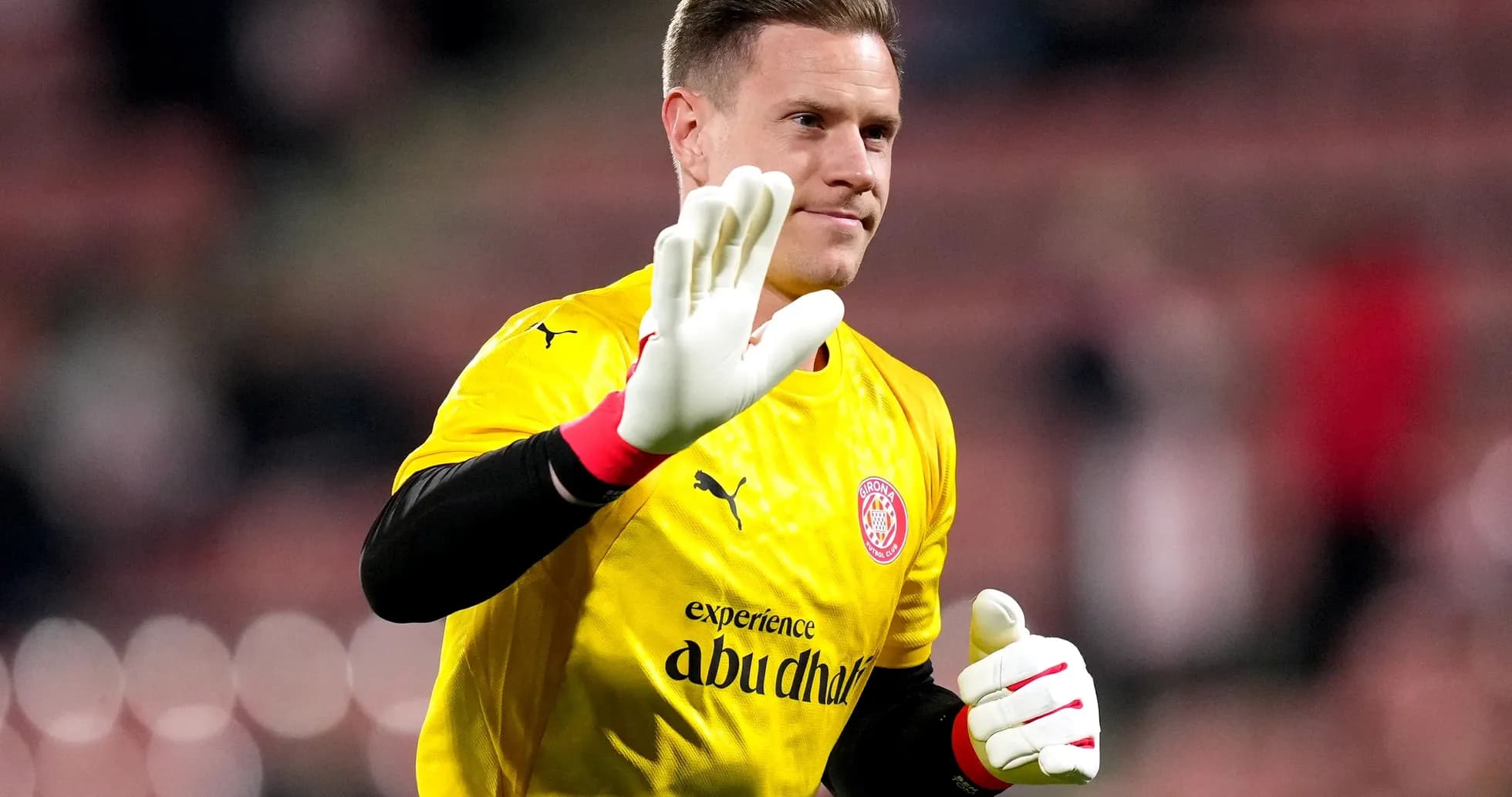 Goalkeeper waving in yellow jersey during match