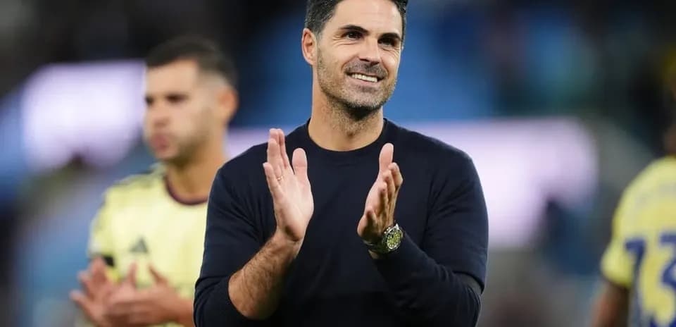 Coach clapping during match celebration with players