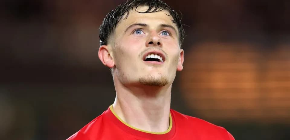 Player in red jersey looking upwards during match