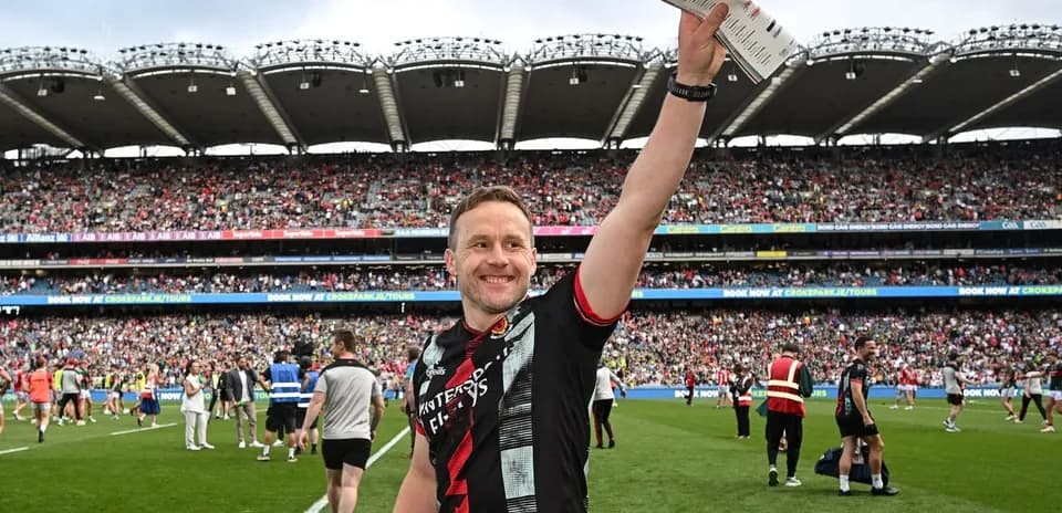 Player celebrating with fans in packed stadium