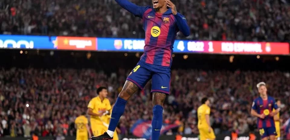 Barcelona player celebrating goal in packed stadium