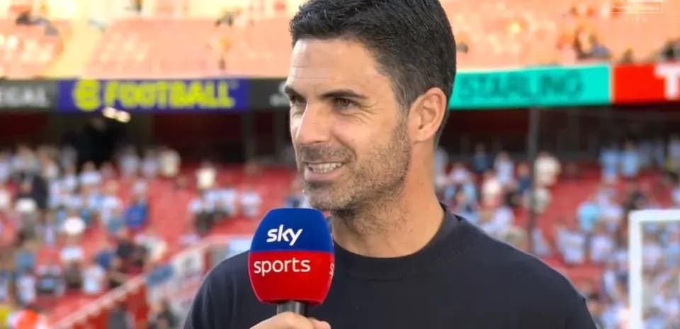 Manager speaking during pre-match interview on field