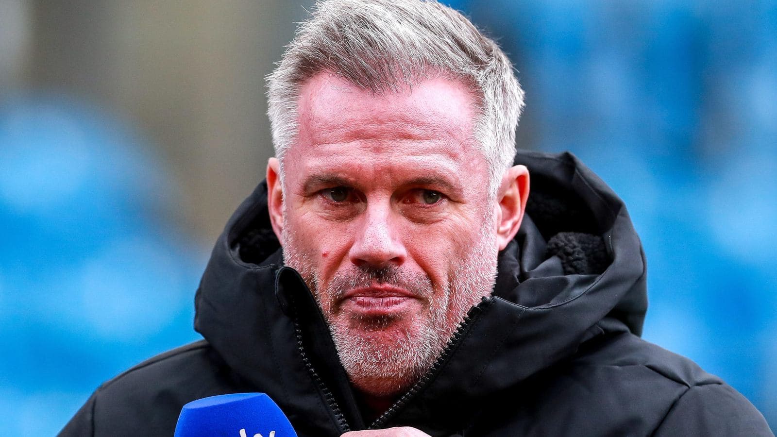Man speaking into microphone during interview