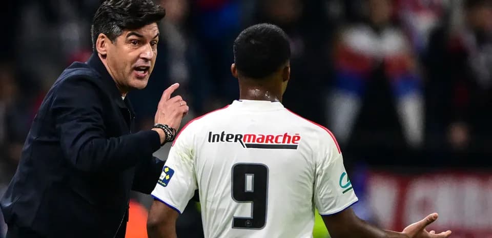 Coach instructing player during match on sidelines