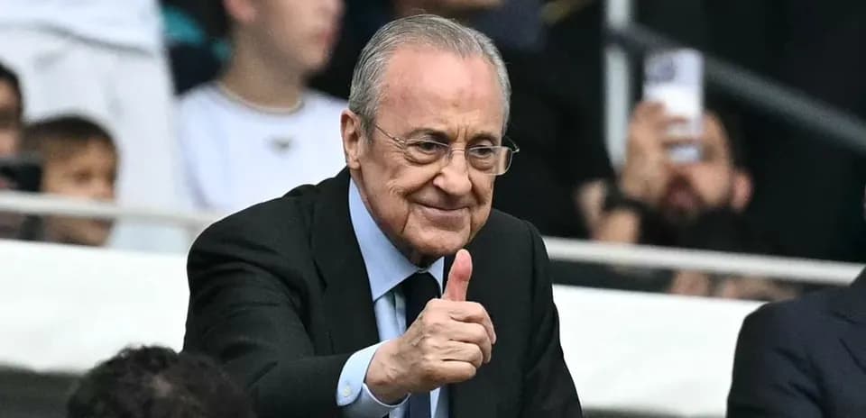 Club president giving thumbs up in stadium