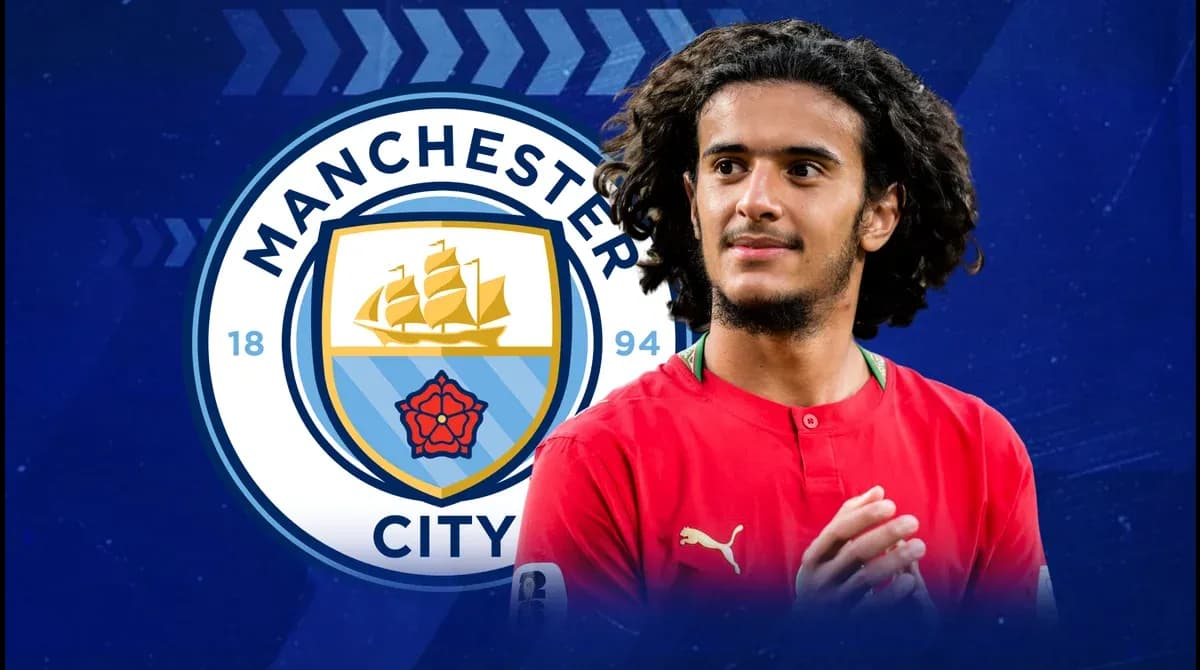 Player in red jersey with Manchester City logo background