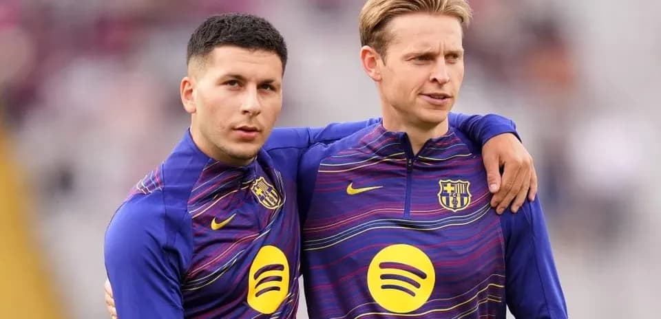 Two players in FC Barcelona training kits standing together
