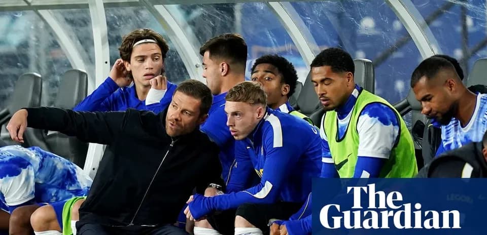 Coach instructing players on the bench during match