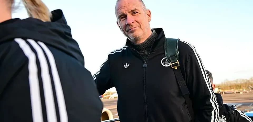 Coach in team tracksuit at airport boarding