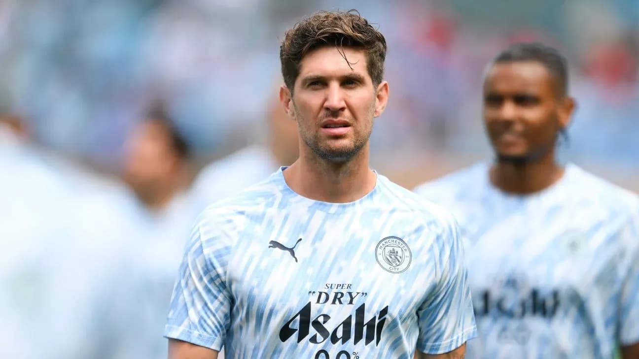 Player in Manchester City training kit on pitch Player in Manchester City training kit on pitch