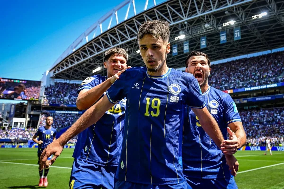 Bosnia players celebrating a goal on the pitch Bosnia players celebrating a goal on the pitch