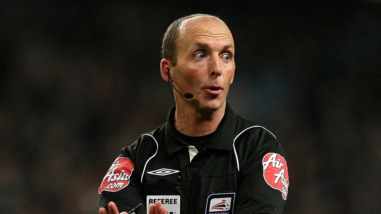 Referee officiating a match with microphone and gestures Referee officiating a match with microphone and gestures