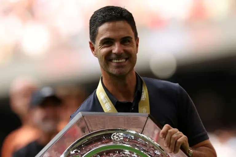 Manager holding trophy during victory celebration Manager holding trophy during victory celebration