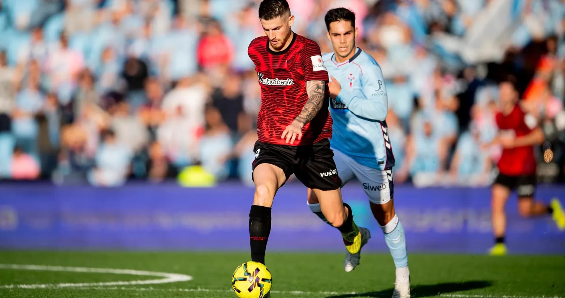 Athletic Club player dribbling against Celta Vigo Athletic Club player dribbling against Celta Vigo