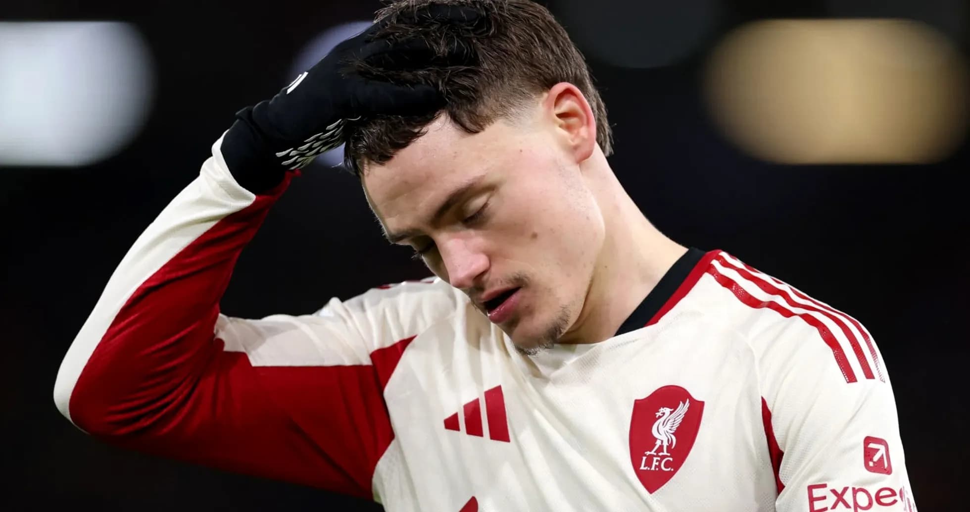 Player in Liverpool kit looks disappointed on field Player in Liverpool kit looks disappointed on field