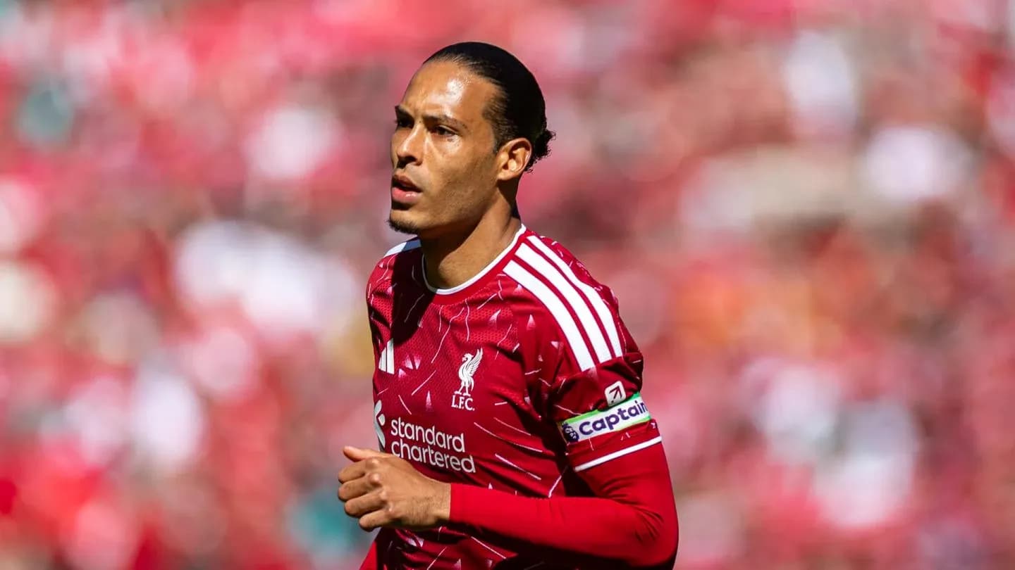 Player in Liverpool kit running on the pitch Player in Liverpool kit running on the pitch