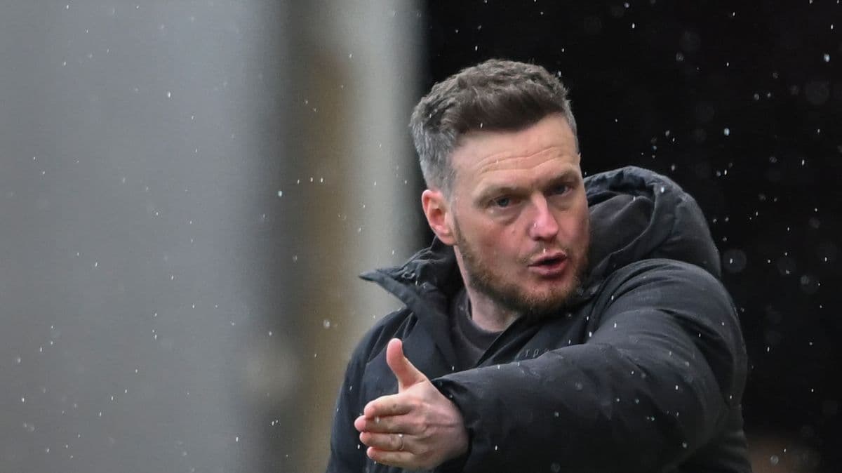 Coach gesturing during a rainy match Coach gesturing during a rainy match
