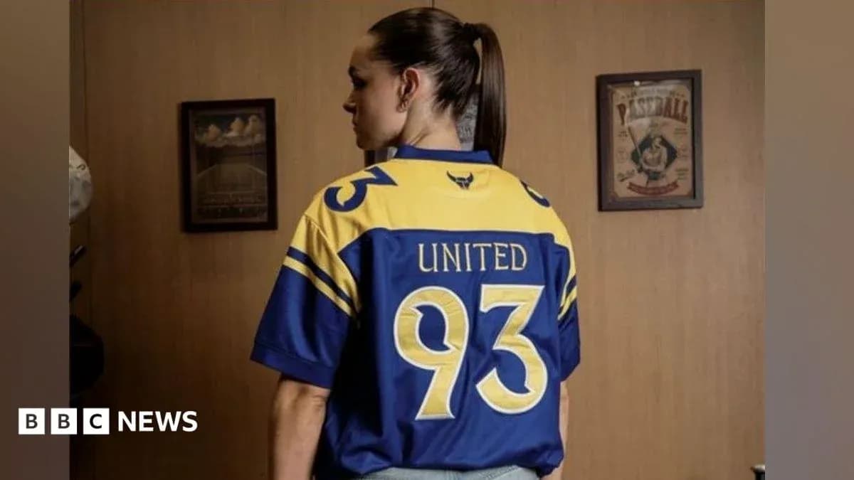 Person wearing a blue and yellow jersey with '93' and 'UNITED' on back Person wearing a blue and yellow jersey with '93' and 'UNITED' on back