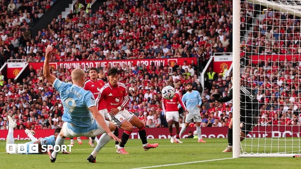 Player attempting to score during Manchester derby match Player attempting to score during Manchester derby match