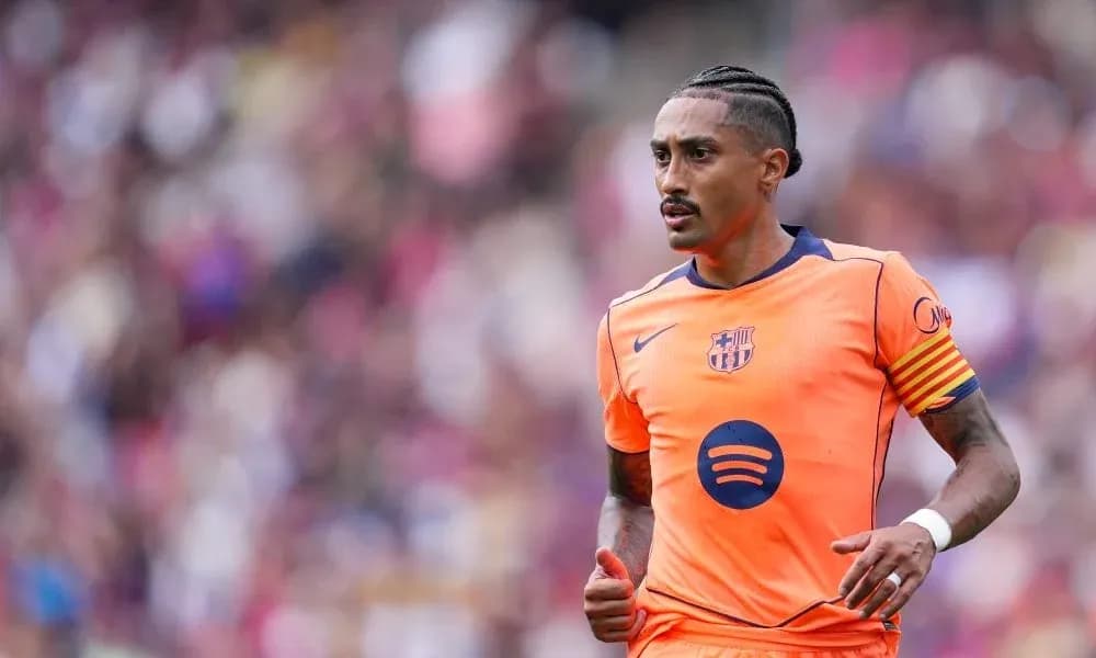 Player in orange Barcelona kit running on field Player in orange Barcelona kit running on field