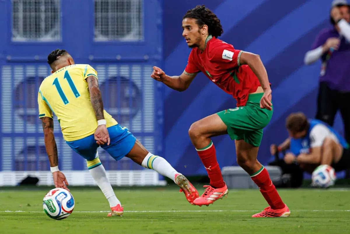 Brazilian player dribbling past Moroccan defender on field Brazilian player dribbling past Moroccan defender on field