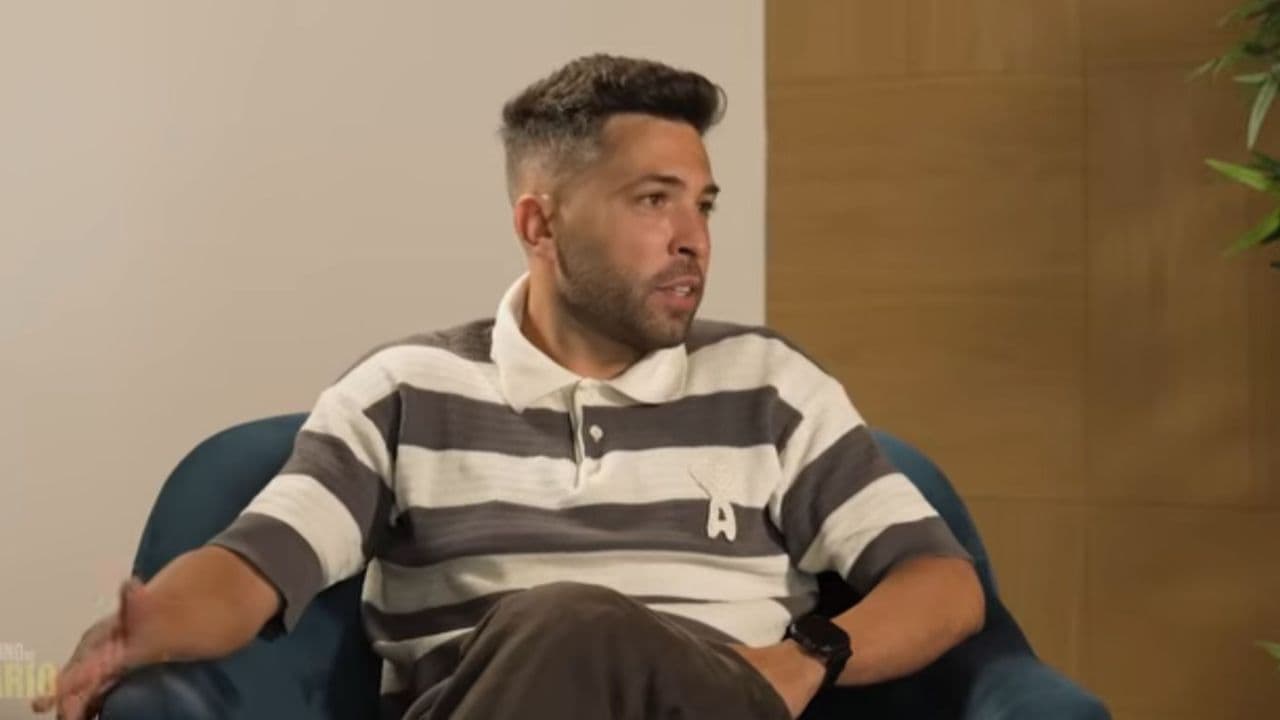 Man speaking during an interview seated on a couch Man speaking during an interview seated on a couch