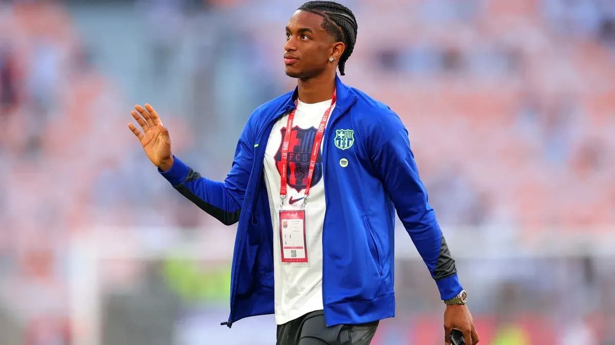 Player waving while wearing a team jacket Player waving while wearing a team jacket