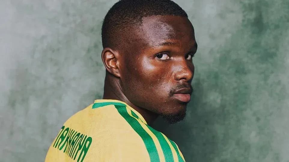 Player wearing yellow jersey looking over shoulder Player wearing yellow jersey looking over shoulder