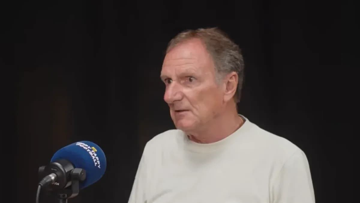 Person speaking at a microphone during interview Person speaking at a microphone during interview