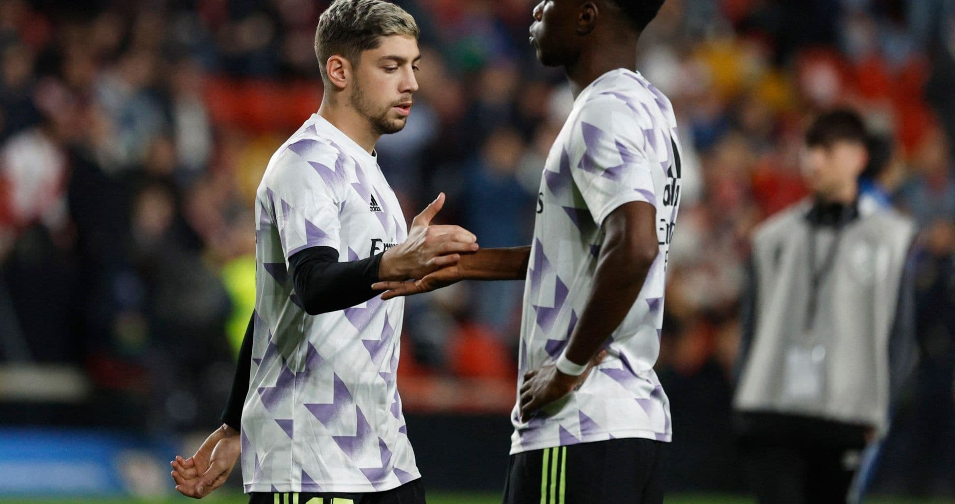 Two Real Madrid players exchanging gestures on field Two Real Madrid players exchanging gestures on field