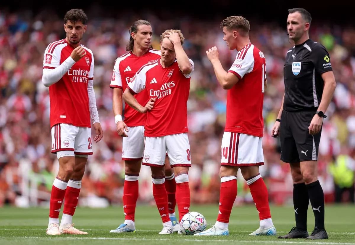 Arsenal players discussing strategy with referee Arsenal players discussing strategy with referee
