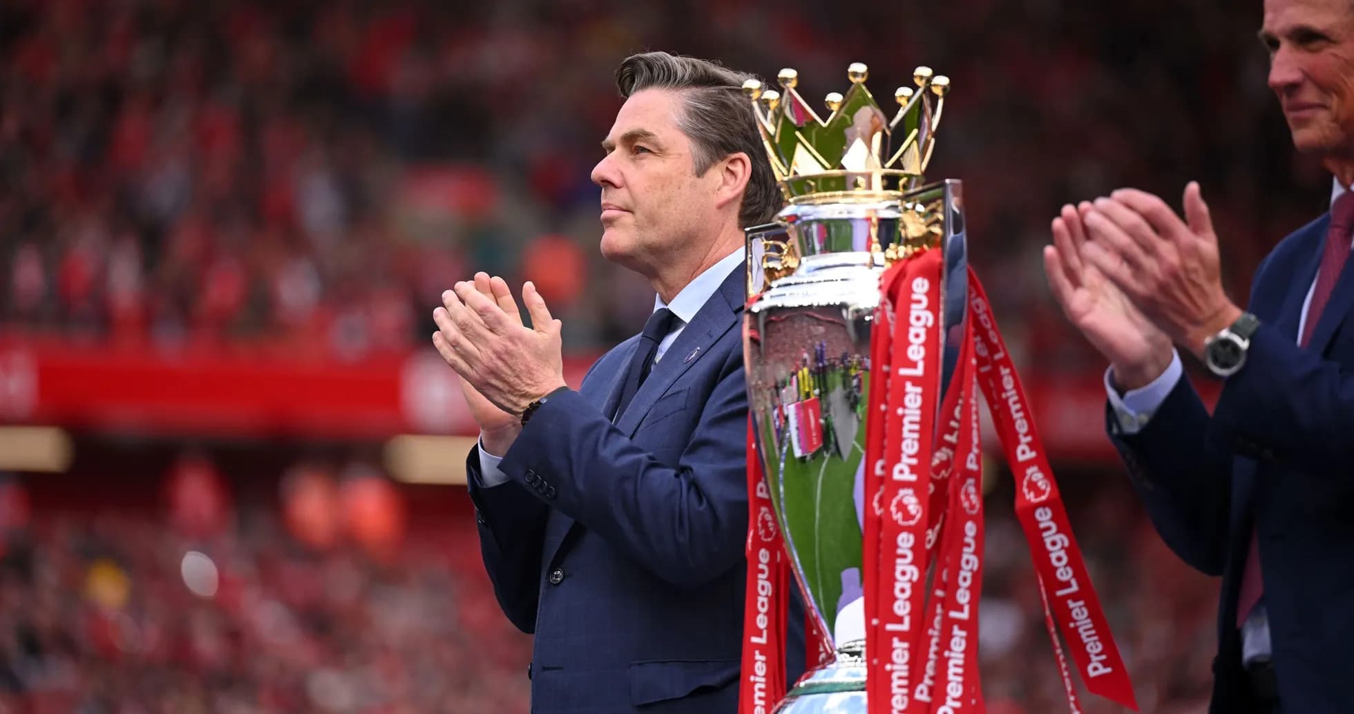 Man applauding near Premier League trophy presentation Man applauding near Premier League trophy presentation