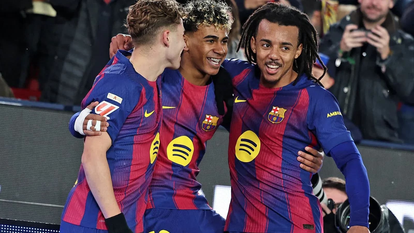 Three FC Barcelona players celebrating a goal Three FC Barcelona players celebrating a goal