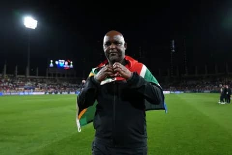 Man wearing South African flag on the field Man wearing South African flag on the field