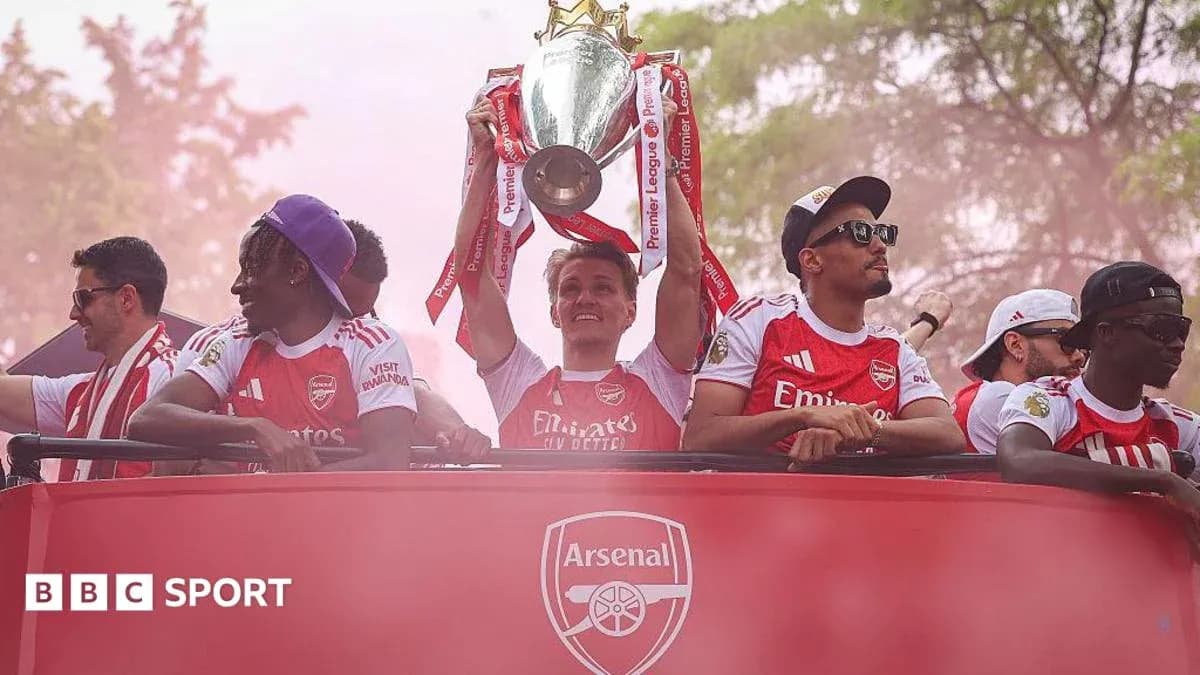 Arsenal players celebrating with Premier League trophy Arsenal players celebrating with Premier League trophy