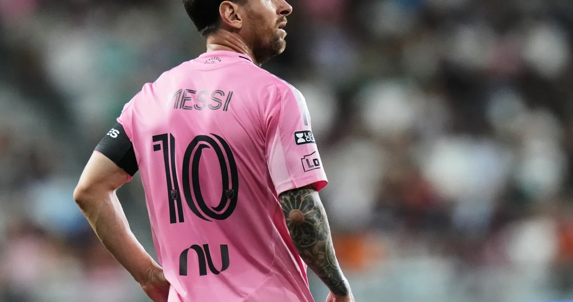 Player wearing pink jersey with 'Messi' and number 10 Player wearing pink jersey with 'Messi' and number 10