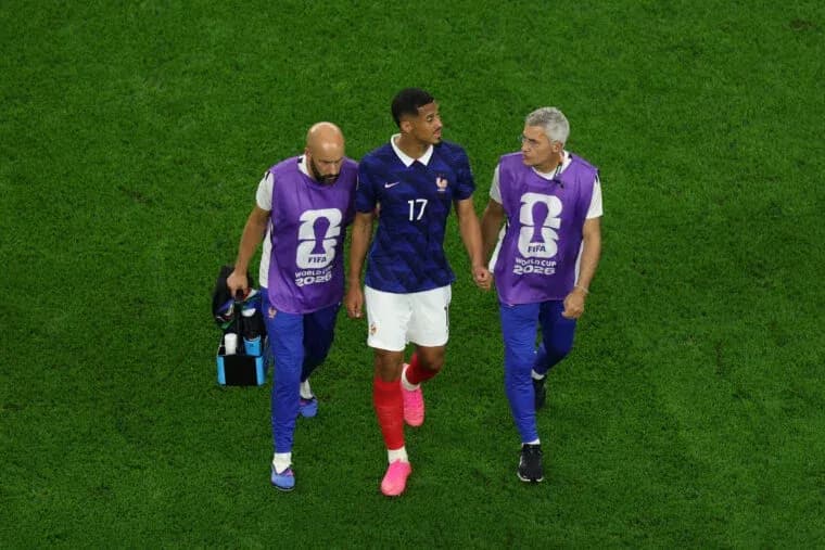 Player leaving field with medical staff during match Player leaving field with medical staff during match