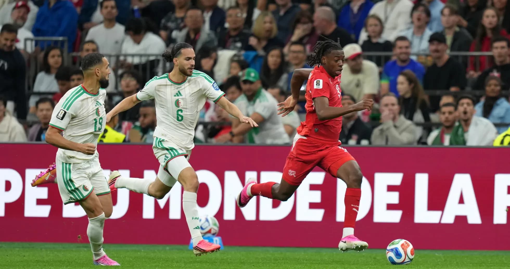Switzerland player running with ball against Algeria Switzerland player running with ball against Algeria