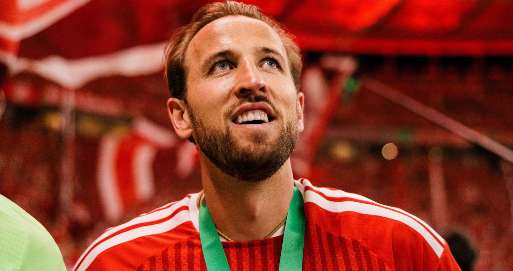 Player celebrating with medal in stadium atmosphere Player celebrating with medal in stadium atmosphere