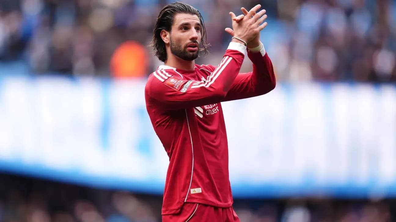 Player in red jersey applauding fans during match Player in red jersey applauding fans during match